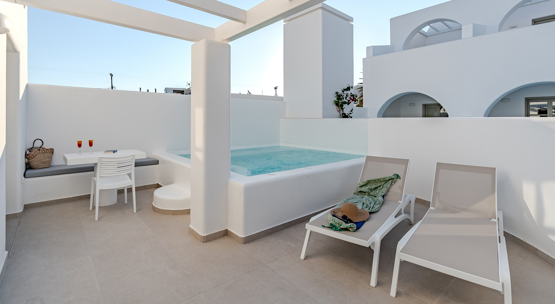 Private pool terrace with sun loungers at the Signature Double Room of Antoperla Adults Only Santorini Hotel