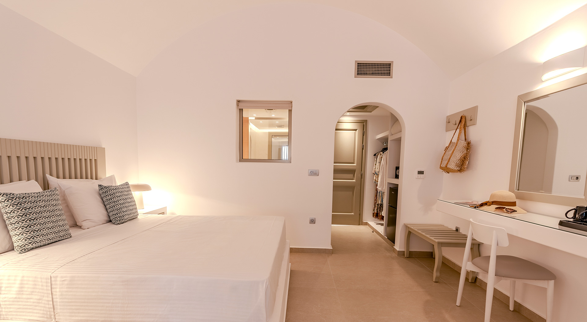 Signature Double Room bedroom with double bed and dressing area at Antoperla Adults Only Santorini Hotel