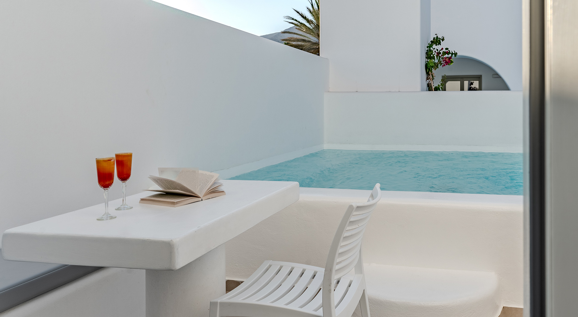 Poolside seating area beside the private pool of the Signature Double Room at Antoperla Adults Only Santorini Hotel