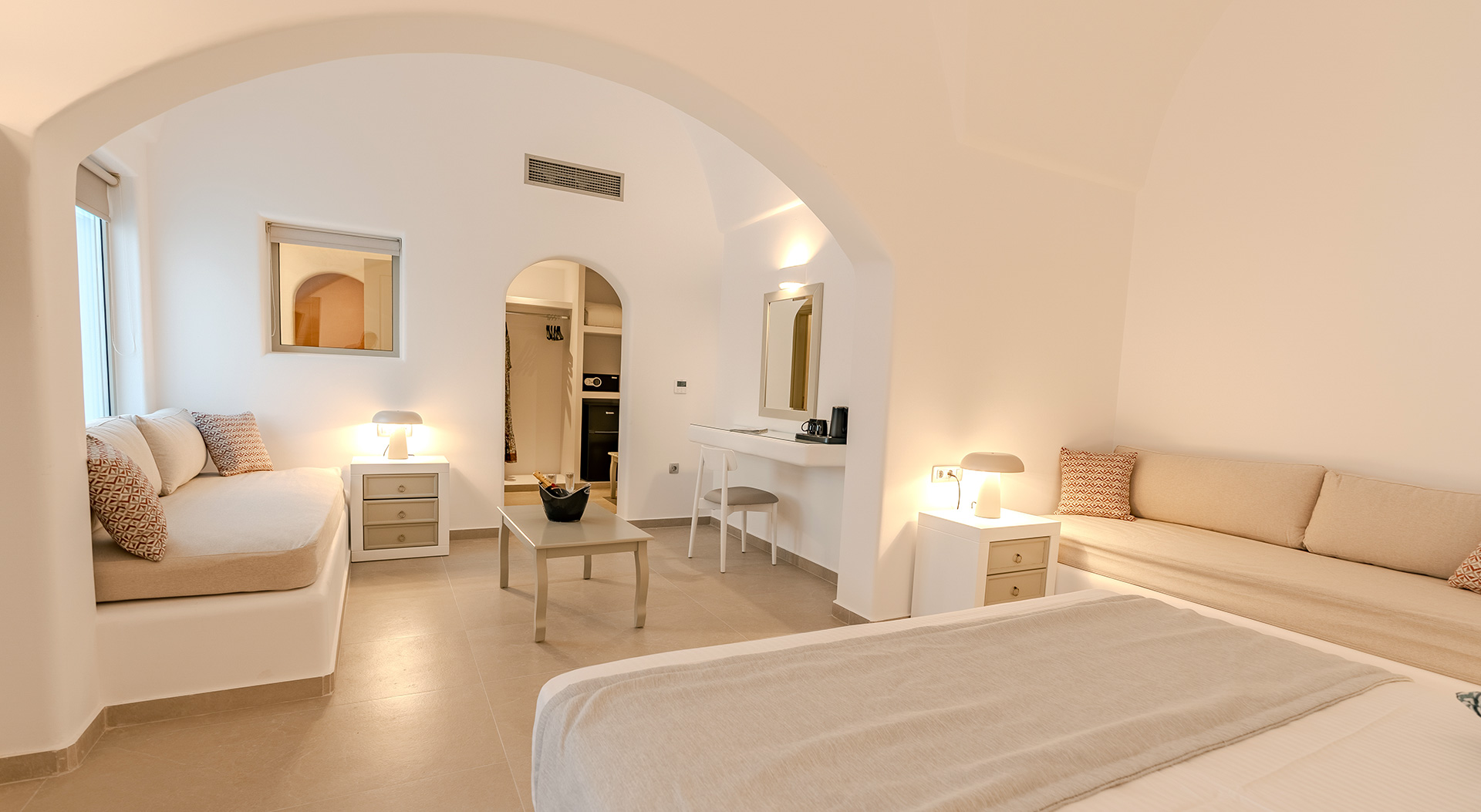 Open-plan bedroom and lounge area of the Signature Suite at Antoperla Adults Only Santorini Hotel