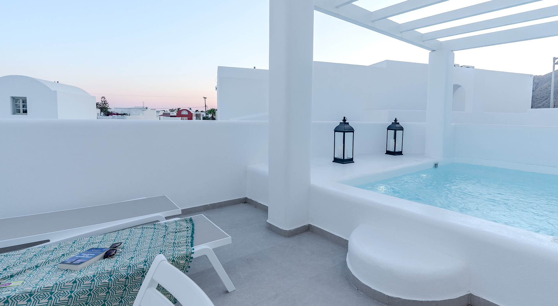 Private pool terrace with sun loungers at the Signature Open Plan Suite of Antoperla Adults Only Santorini Hotel